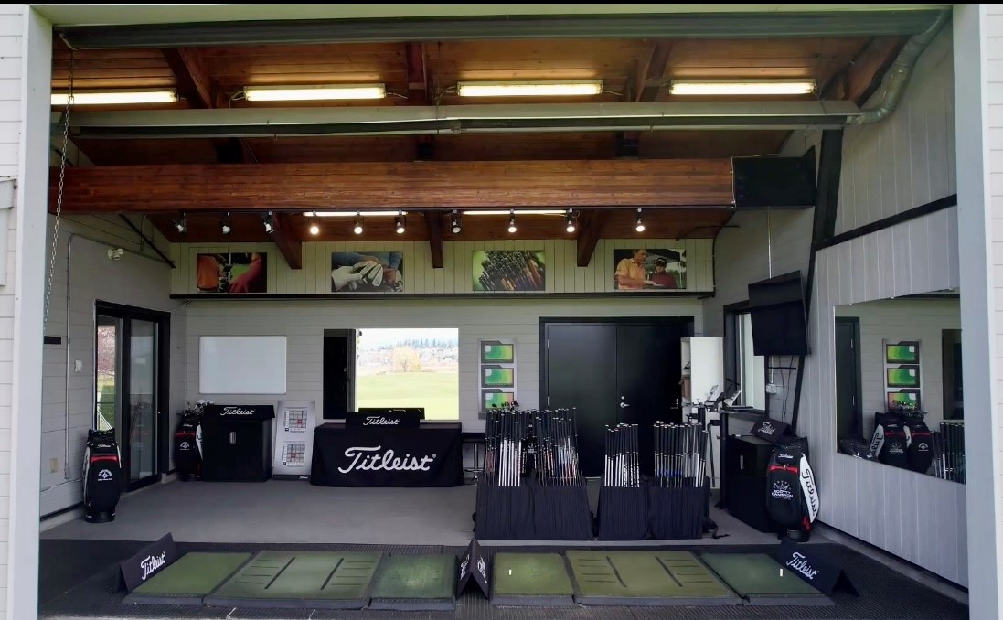 Inside of the fitting range with various golfing equipment