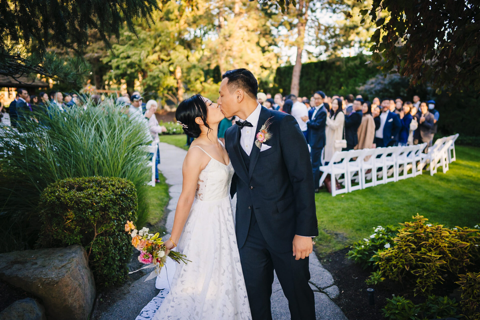 Bride and groom sharing a kiss during their wedding ceremony