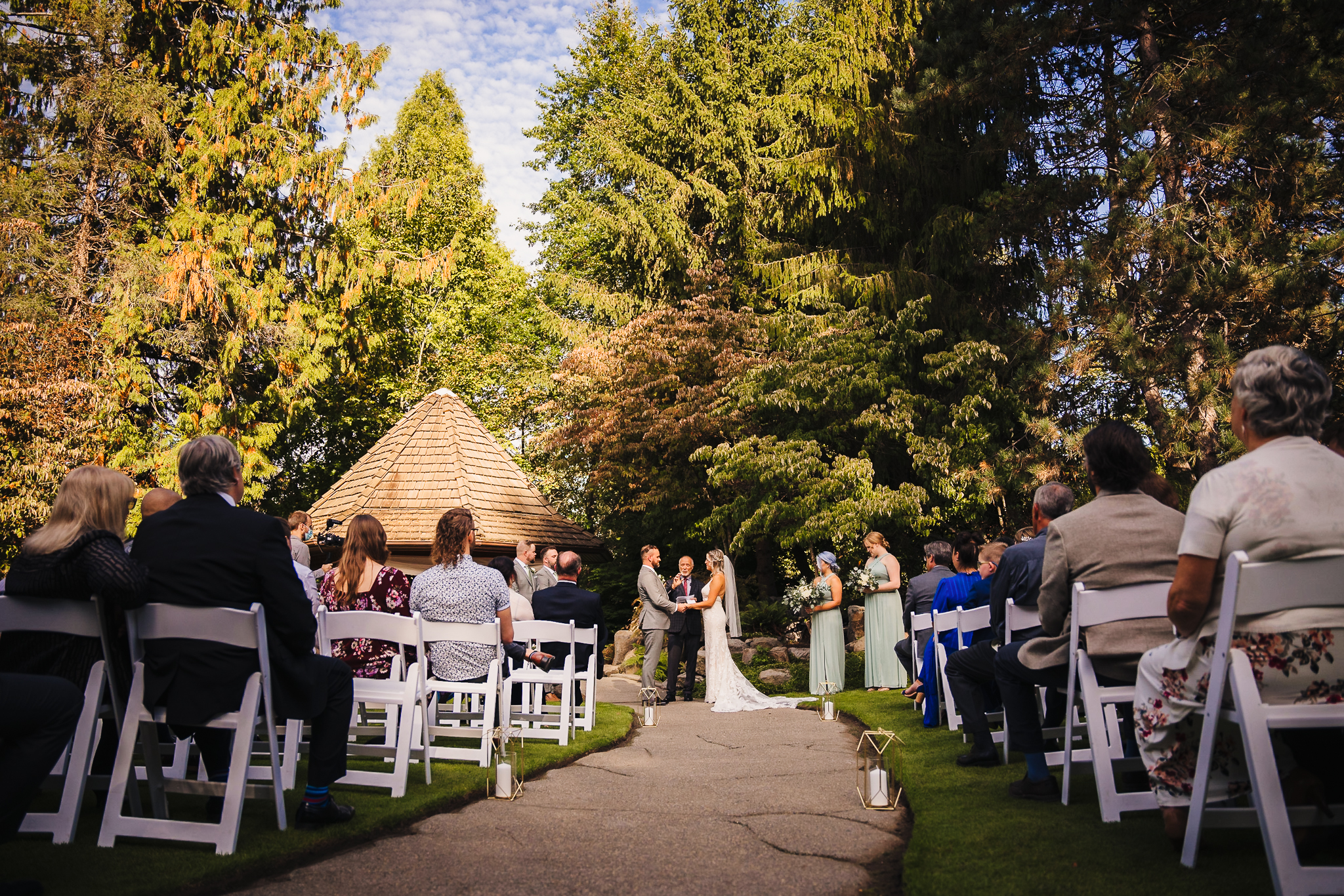Wedding ceremony at the enchanted garden, with the bride and groom holding hands