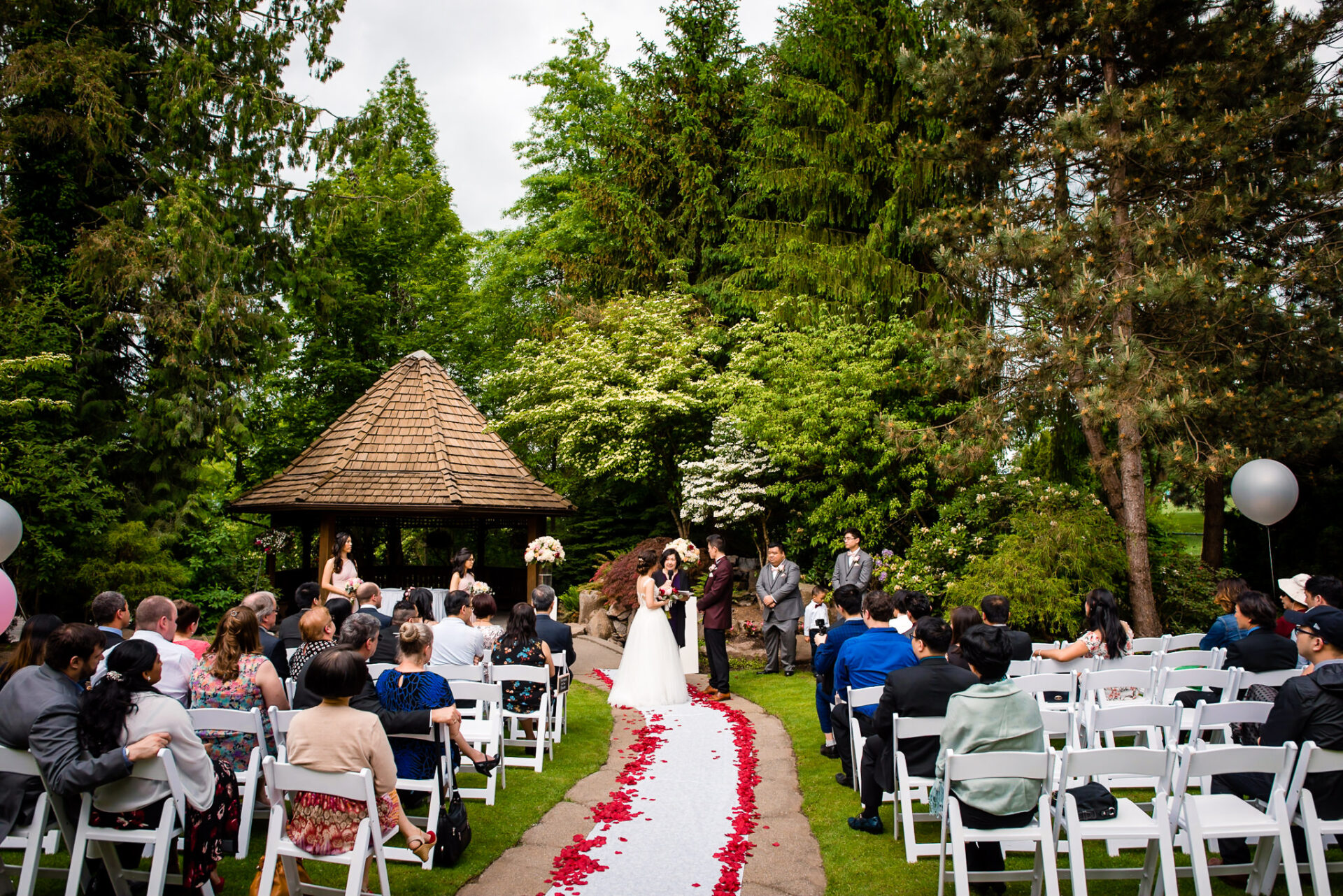 View of the wedding party and guests within the enchanted garden