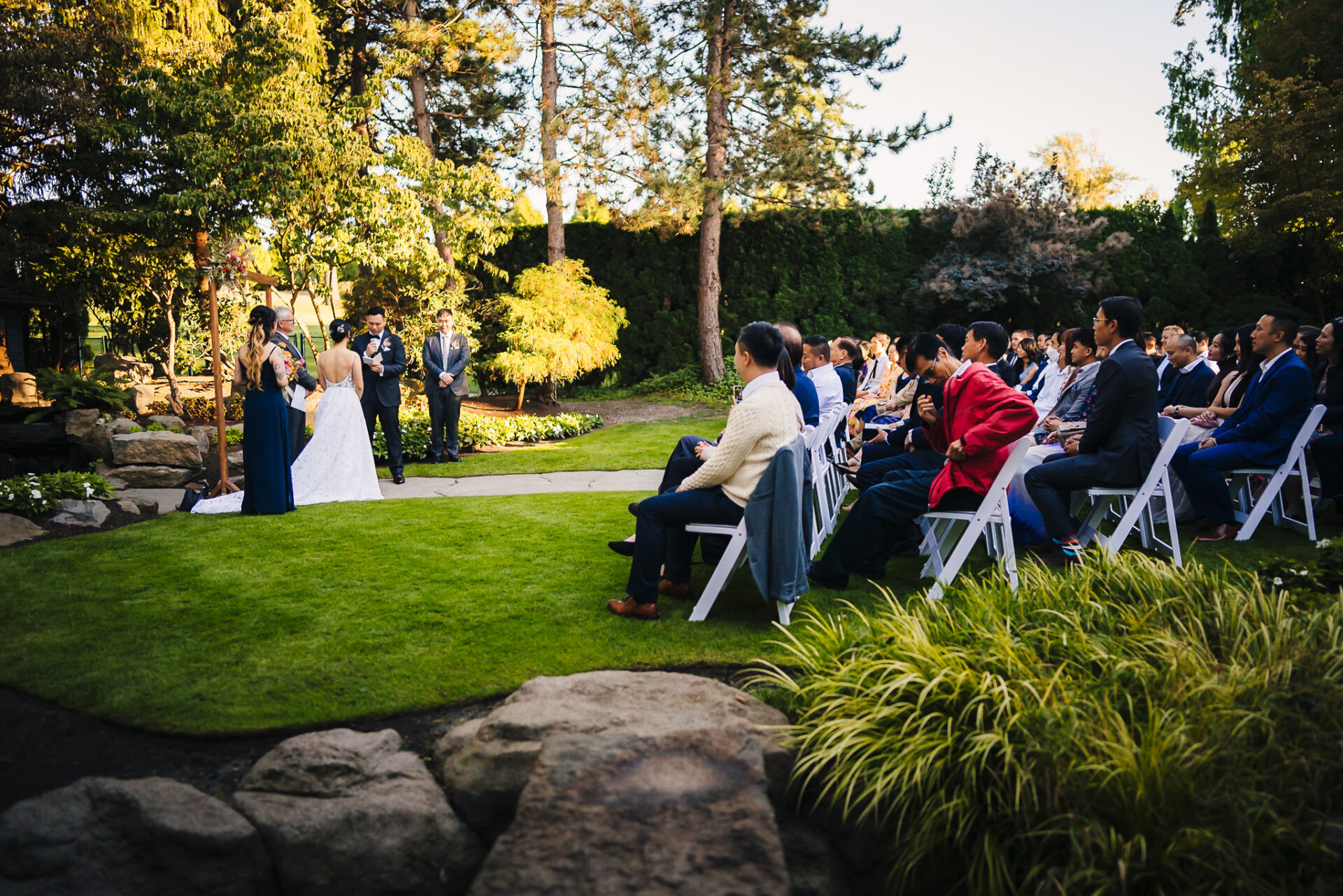 Side view of the wedding party and guests within the enchanted garden