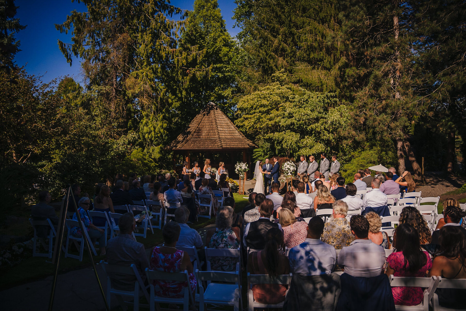 View of the wedding party and guests within the enchanted garden