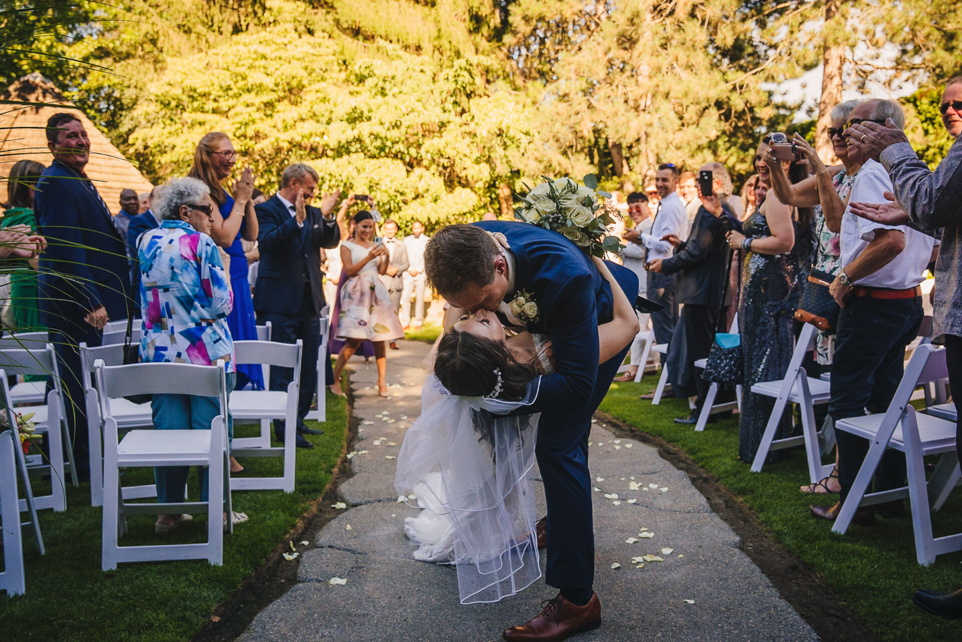 Bride and groom share a kiss during their wedding ceremony