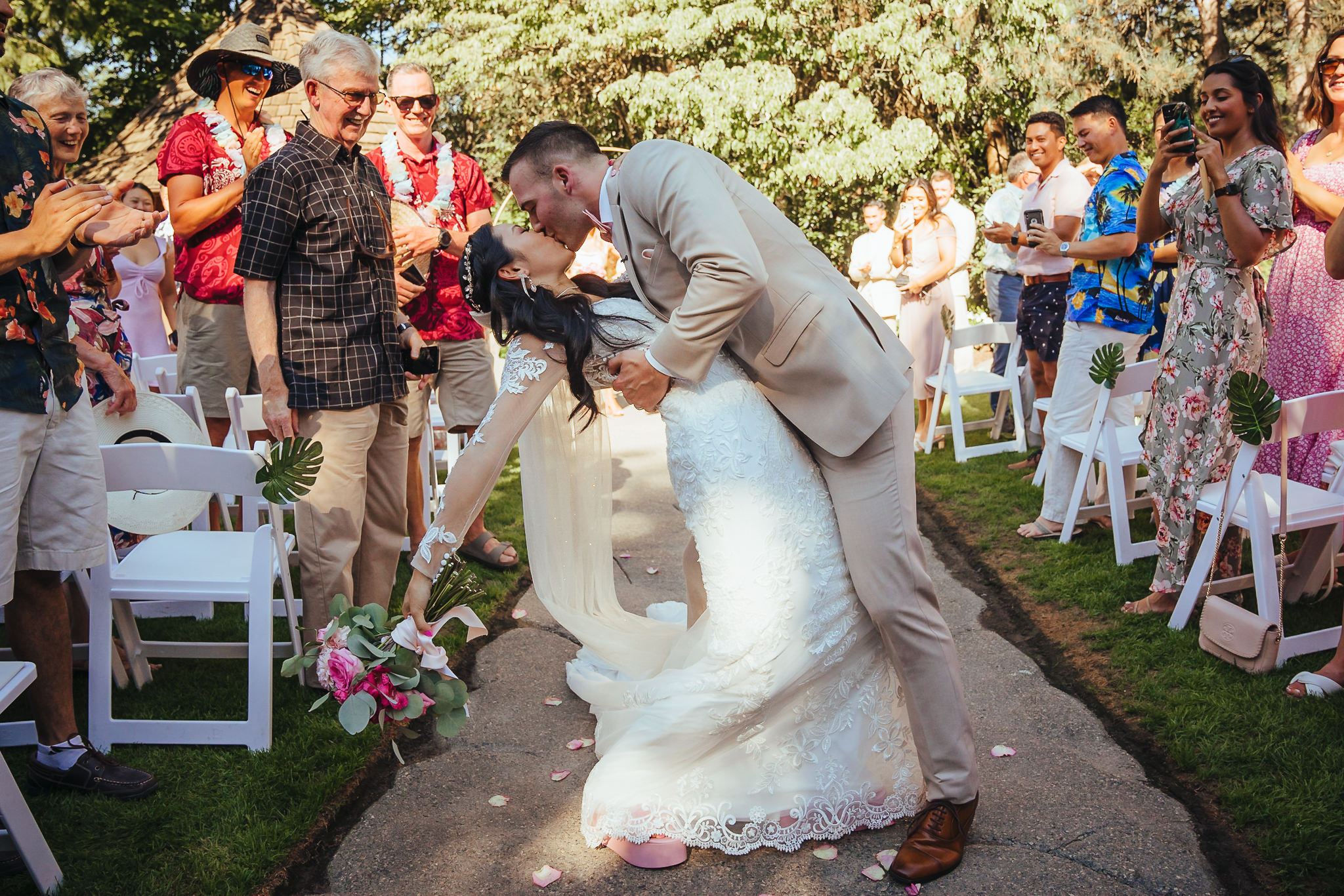 Bride and groom share a kiss during their wedding ceremony