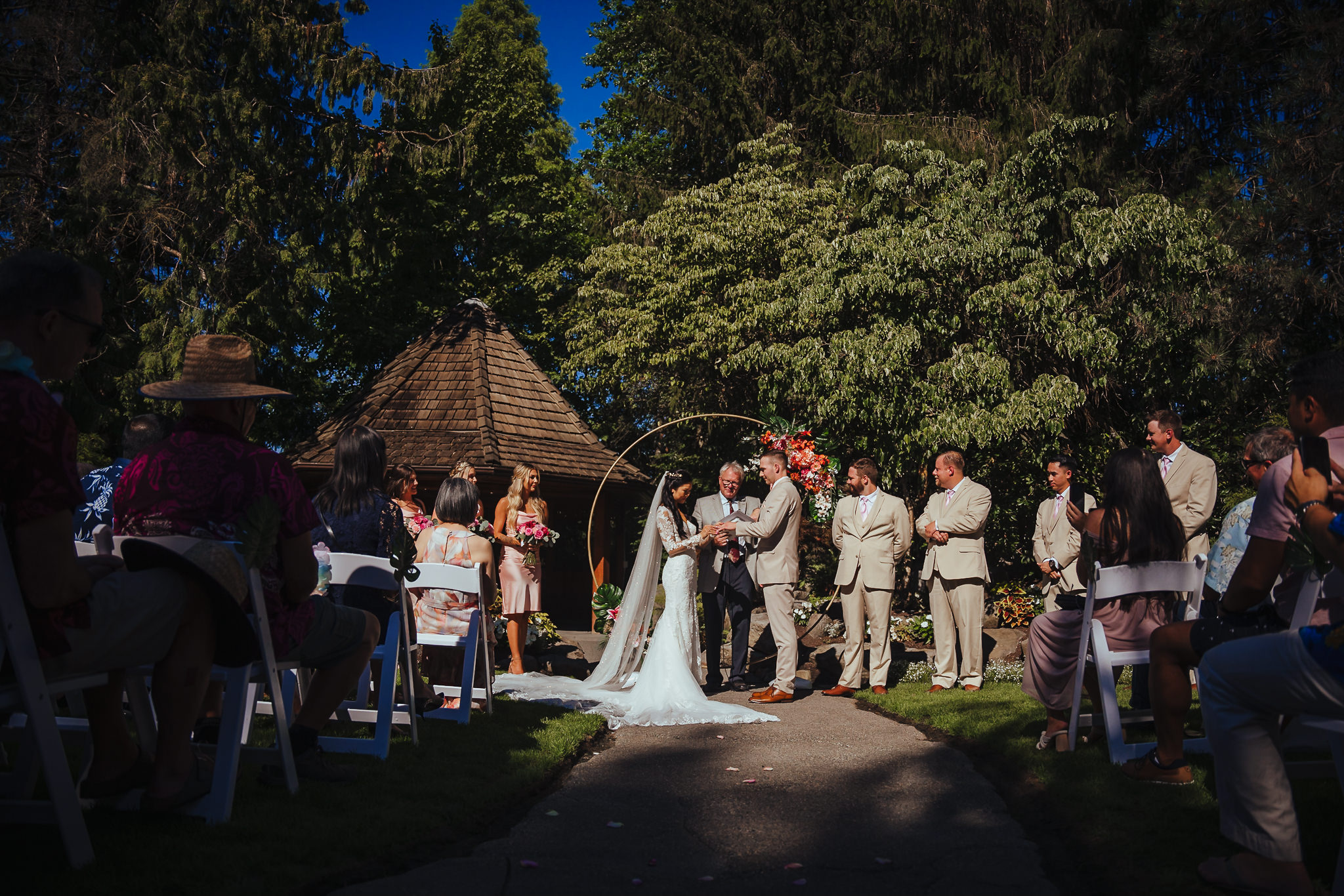 Bride inserting the ring on to the groom's finger