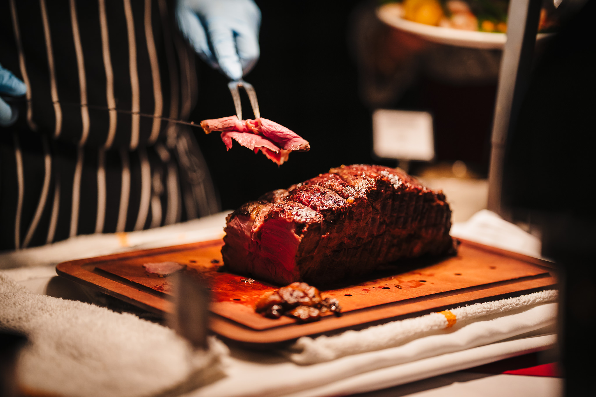 Close up of chef cutting a roast