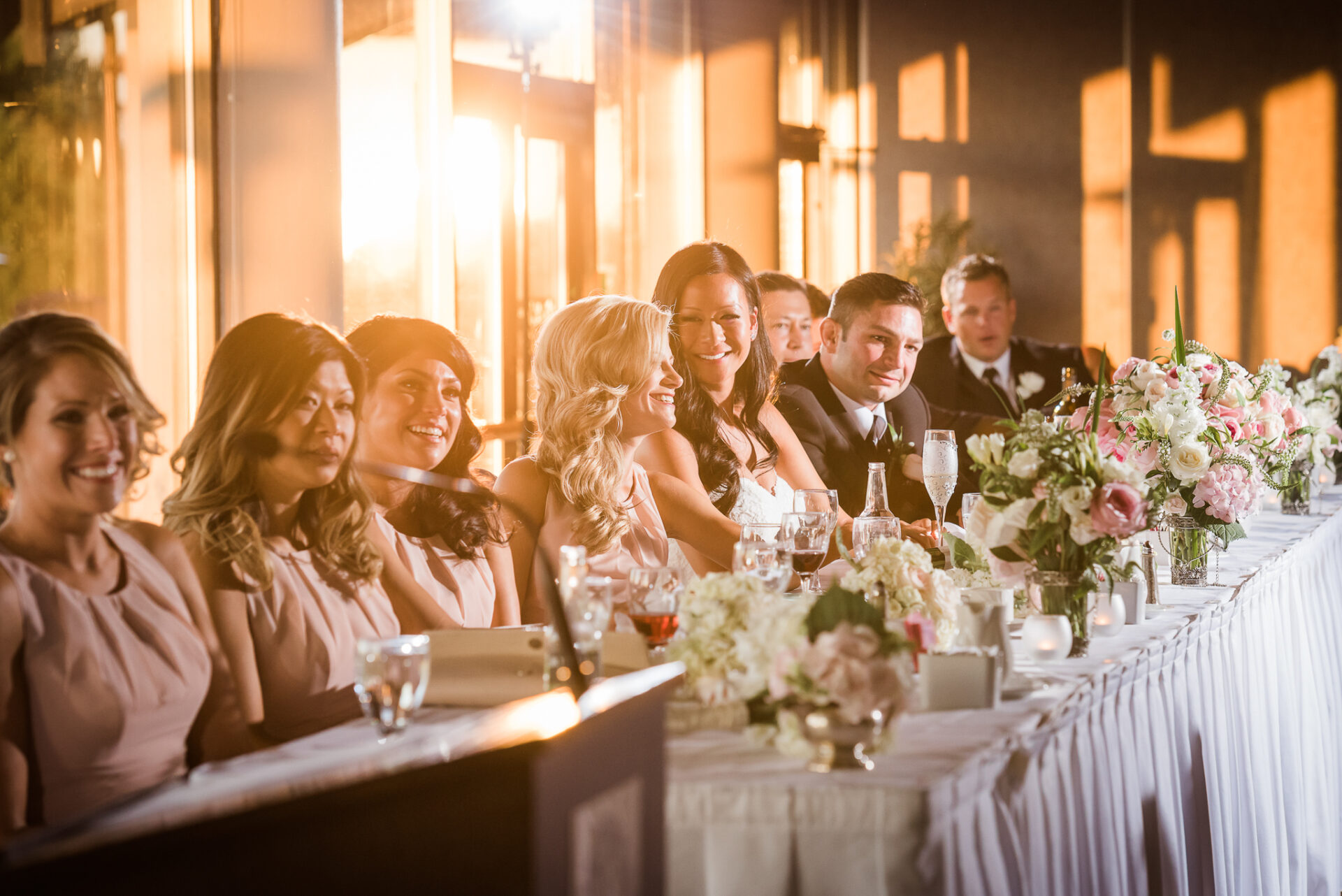Wedding party smiling while conversing with each other