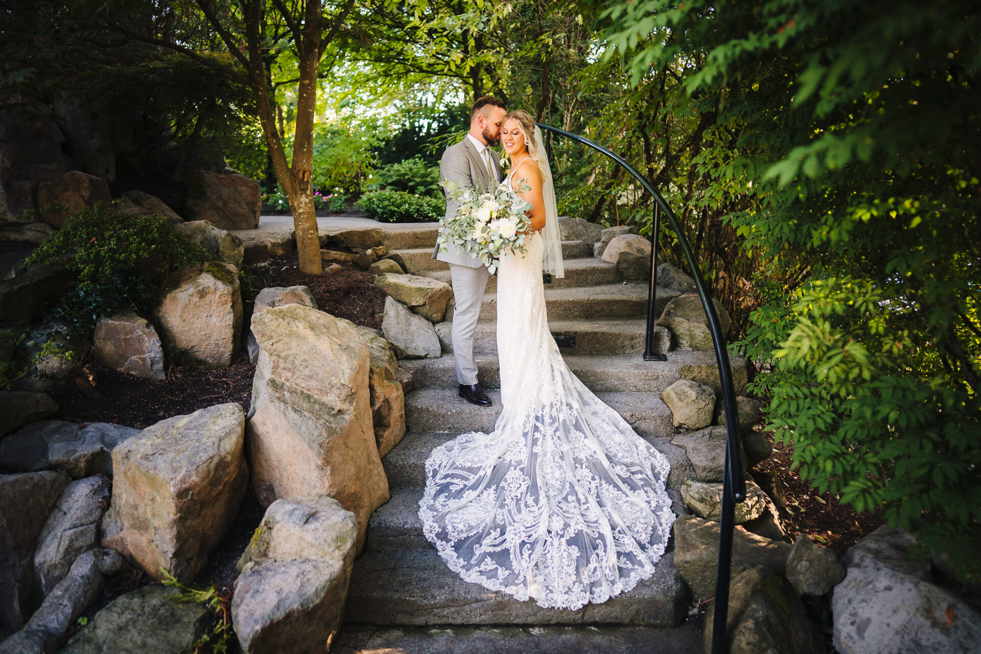 Bride and groom posing for a photo on a set of stairs