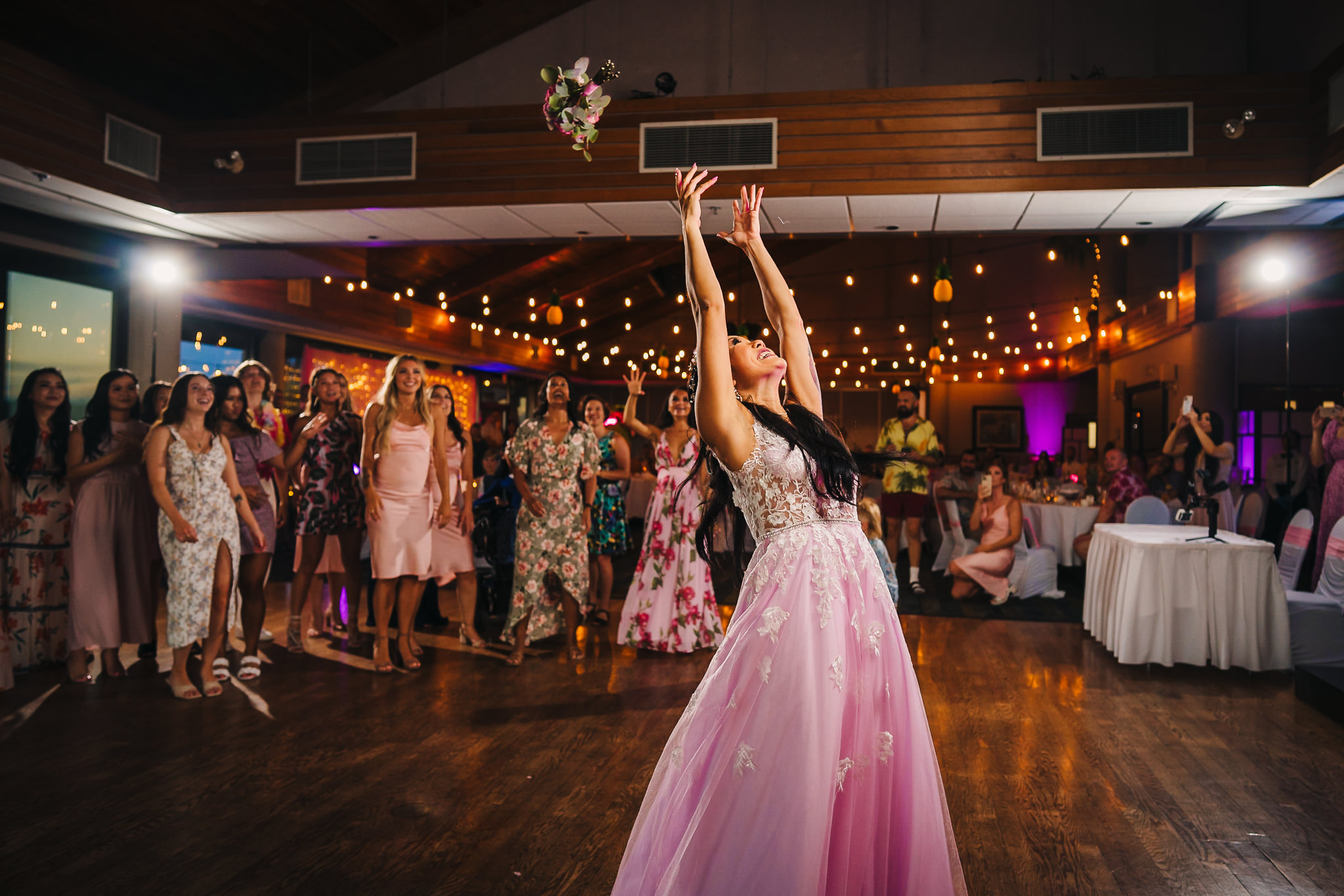 Bride throwing a bouquet of flowers 