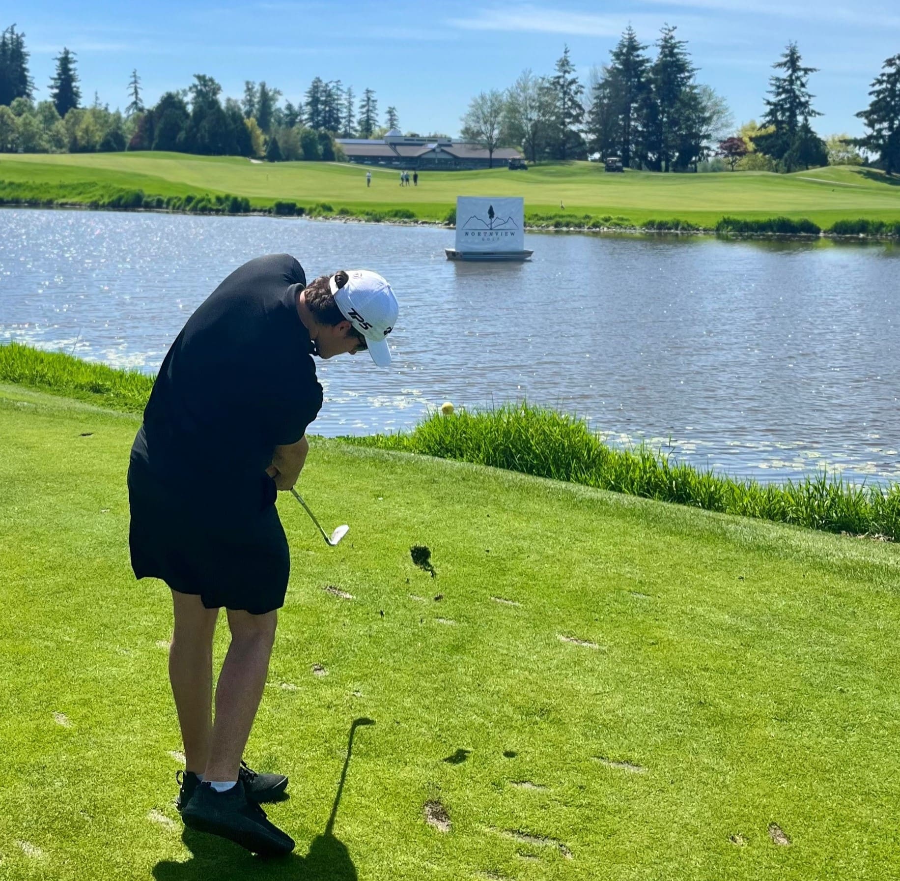 Male golfer in mid swing stance