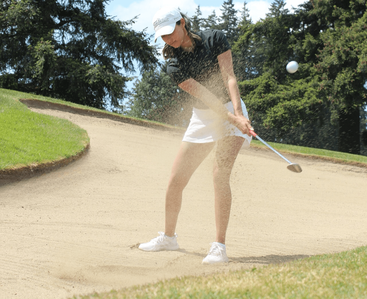 Female golfer in mid swing stance