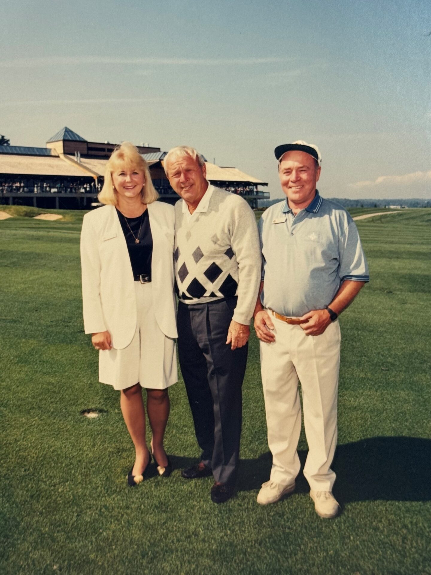 Arnold Palmer posing for a photo with Mr and Mrs Stewart